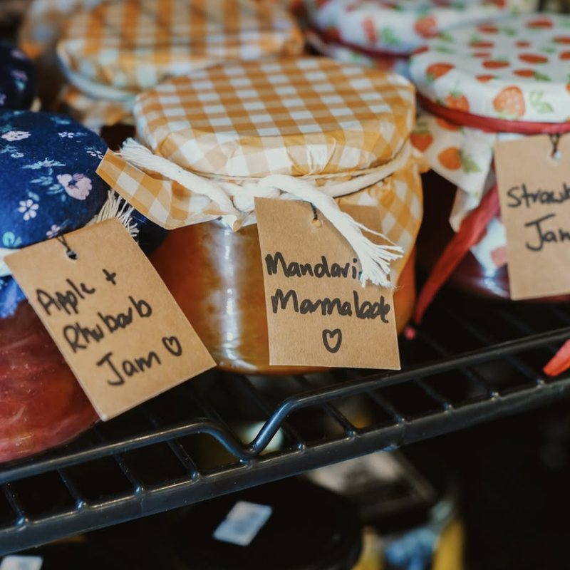 Homemade apple and rhubarb jam, mandarin marmalade and strawberry jam with handwritten tags